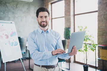 Photo of attractive young man netbook presentation dressed formalwear clothes executive business leader comfort beautiful office interior
