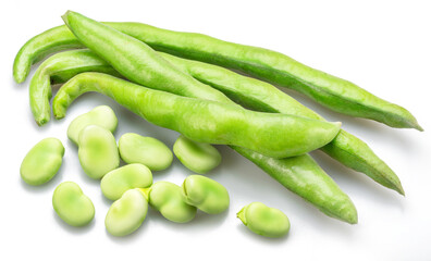 Green broad bean pod and several broad beans isolated on white background.