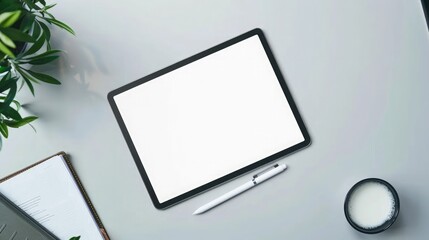 Fototapeta premium Top view of modern workplace with blank screen tablet computer, stationery and plant. Mock up