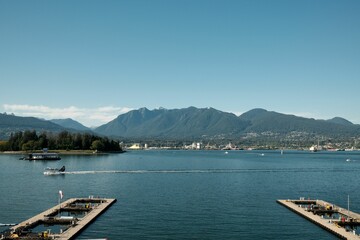 Obraz premium Scenic view of a harbor with a seaplane, landing on a clear day in Vancouver, Canada