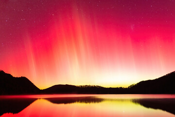 The Aurora Australis (Southern Lights) blazing in the night sky above a lake in New Zealand