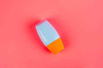 Blank tube with cosmetic product for moisturizing on pink background