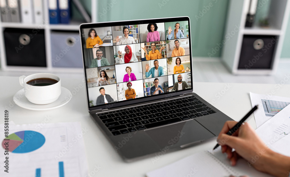 Poster a laptop screen displays a video conference meeting with a grid of multiple participants, all of who