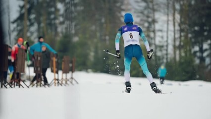 Athlete skiing. Ski competition. Shot from behind