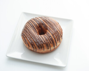 Chocolate frosted donut with sprinkles isolated on a white background.
