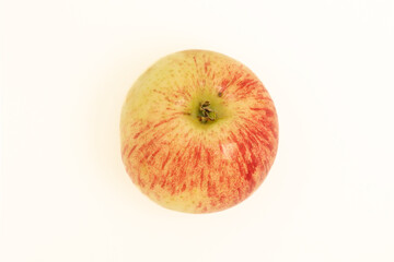 Top view of a red apple on a white table