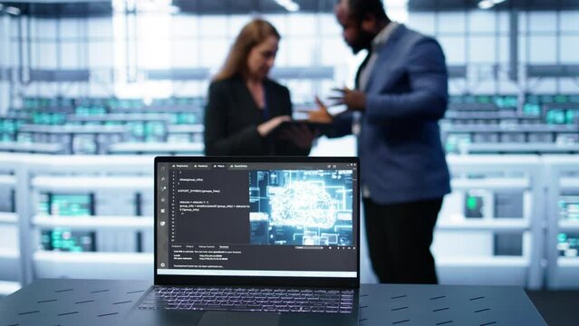 Laptop in data center establishment with artificial intelligence computing simulating human brain. Close up shot of notebook displaying AI machine learning algorithms, camera B