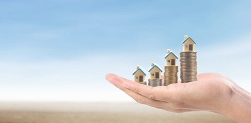 Hands and stock coins and model house ,money saving ,Business idea