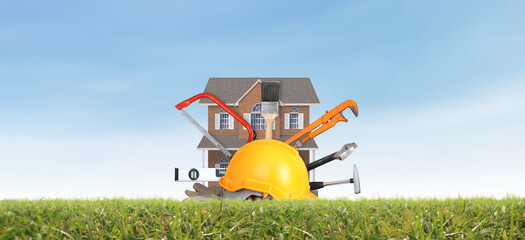Yellow hardhat and old leather gloves and model house grass as fokaw