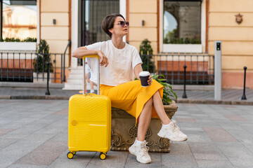 stylish woman traveling with yellow suitcase in Europe © mary_markevich