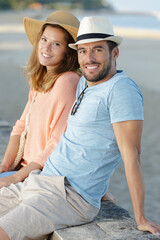 happy young couple in casual white clothes relaxing by sea