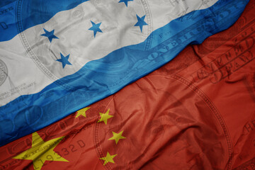 waving colorful flag of honduras and national flag of china on the dollar money background. finance concept.