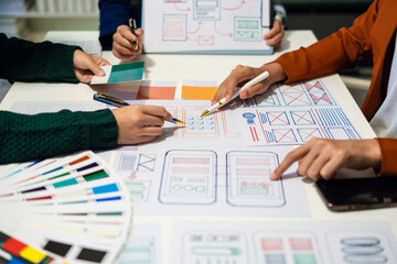 UX developer and ui designer brainstorming about mobile app interface wireframe design with...