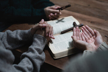 Fototapeta premium Asian men and women hands praying to god with the bible. Pray for god blessing. Religious beliefs Christian life crisis prayer to god.