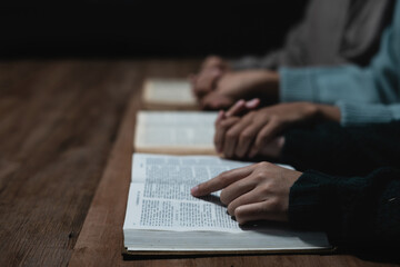 Asian men and women hands praying to god with the bible. Pray for god blessing. Religious beliefs Christian life crisis prayer to god.