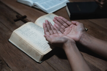 Naklejka premium Asian men and women hands praying to god with the bible. Pray for god blessing. Religious beliefs Christian life crisis prayer to god.