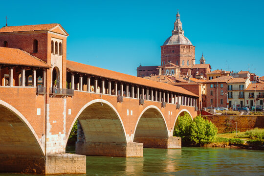 Ponte Vecchio or Covered Bridge of Pavia with the city's cathedral behind it