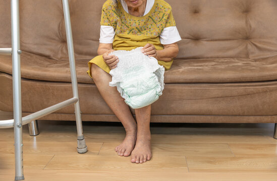 Urinary Incontinence in elderly and changing diaper.