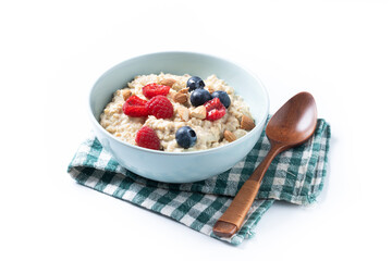 Oatmeal porridge with raspberries, blueberries and almonds in bowl isolated on white background