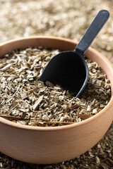 Traditional yerba mate in wooden bowl. Close up