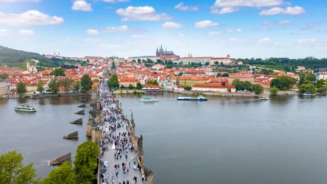 Motion time lapse view of the Charles Bridge and old Lesser town of Prague during a sunny summer day, Czech Republic