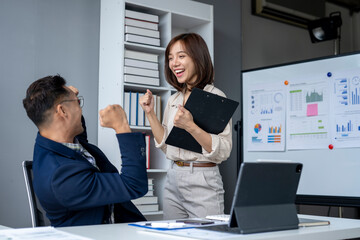 The woman is holding a clipboard and the man is shaking his head