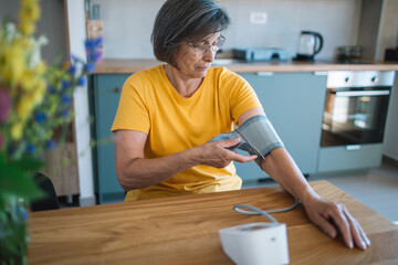 Senior woman checking blood pressure