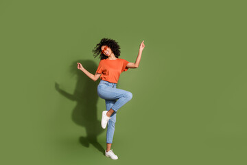 Full body photo of attractive young sunglass dancing dressed stylish orange clothes isolated on khaki color background