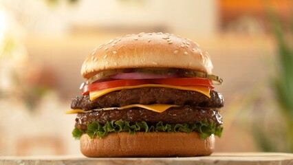 Delicious double cheeseburger with cheese, lettuce, tomato, red onion and bun.