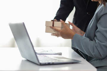 young manager prepared gift box to give to the beautiful secretary in the office to express the love and friendship they had shared between working together for long time. Friendship and love concept