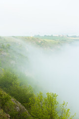 Beautiful landscape photo with mysterious dense fog. Morning with fog.