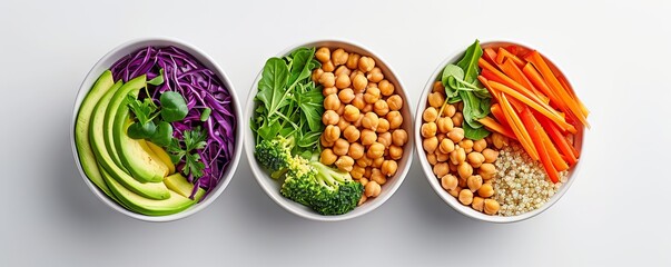 Colorful bowls filled with healthy vegetables, chickpeas, and grains on a white background. Perfect for vegan and healthy food concepts.