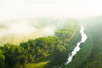 Beautiful landscape photo with mysterious dense fog. Morning with fog.