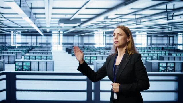 System administrator in high tech data center looking at hologram visualization. Computer scientist working on securing server terminals using AR tech, preventing hacker attacks, camera B