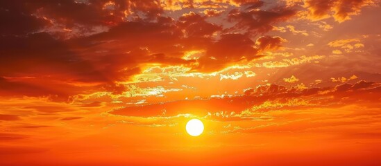Fototapeta premium Deep orange sundown in sky at sunset. Sundown silhouette in sunset sky. Copy space image. Place for adding text or design