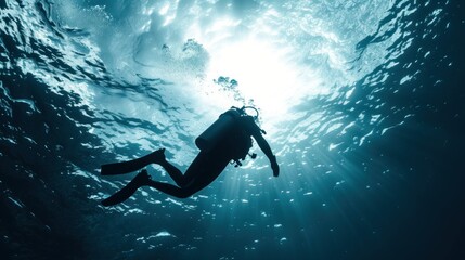 Scuba diver diving on tropical reef with blue background and reef fish