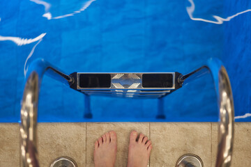 Feet at Pool Ladder Ready to Swim