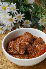 Rendang Daging, a Malaysian traditional dish featuring tender meat cooked in coconut milk and a blend of aromatic spices.