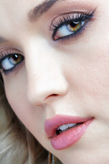 Naklejka premium Beauty portrait of young blonde woman. Female Woman wearing earrings with rhinestones.