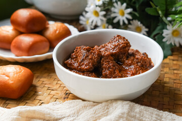Fried Mantou served in white plate with Beef Rendang.  Fusion food.