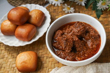Fried Mantou served in white plate with Beef Rendang.  Fusion food.