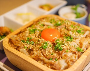 Japanese beef rice bowl bento lunchbox with raw egg Gyudon texture close up view