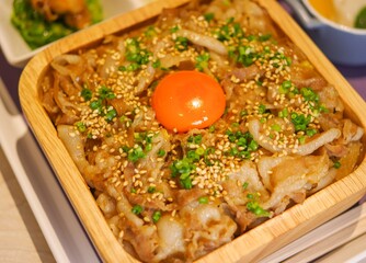 beef bowl bento gyudon with raw egg close up view
