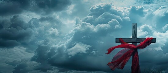 cross with red cloth against the dramatic sky. Copy space image. Place for adding text and design