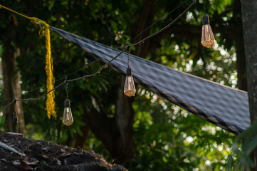 Light bulbs in the park in the afternoon. Afternoon sunlight. Outdoor cafe.
