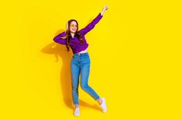 Full body photo of pretty young girl dancing discotheque wear trendy purple outfit isolated on yellow color background