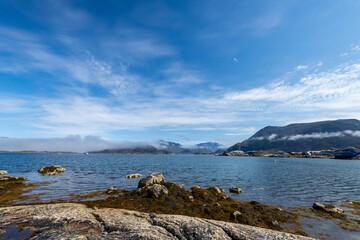 Greenland Nanortalik north sea landscape seascape marina surrounded by fjord mountain peaks on a sunny day