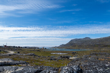 Greenland Nanortalik lava stones volcanic mountain fjord arctic landscape on a sunny day
