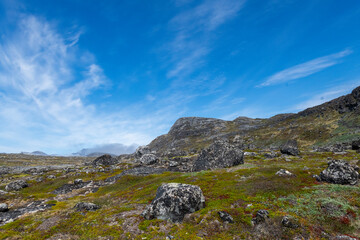 Greenland Nanortalik lava stones volcanic mountain fjord arctic landscape on a sunny day