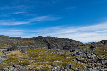Greenland Nanortalik lava stones volcanic mountain fjord arctic landscape on a sunny day